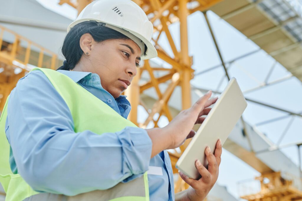Silicone Over & Insert Molding 5 a female engineer in workwear checks her tablet on a construction site highlighting modern engineering practices 8960944 scaled 1